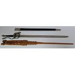 A reproduction Toledo steel sword and a carved wooden wool comb.