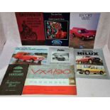 A box of car brochures and motoring ephemera.