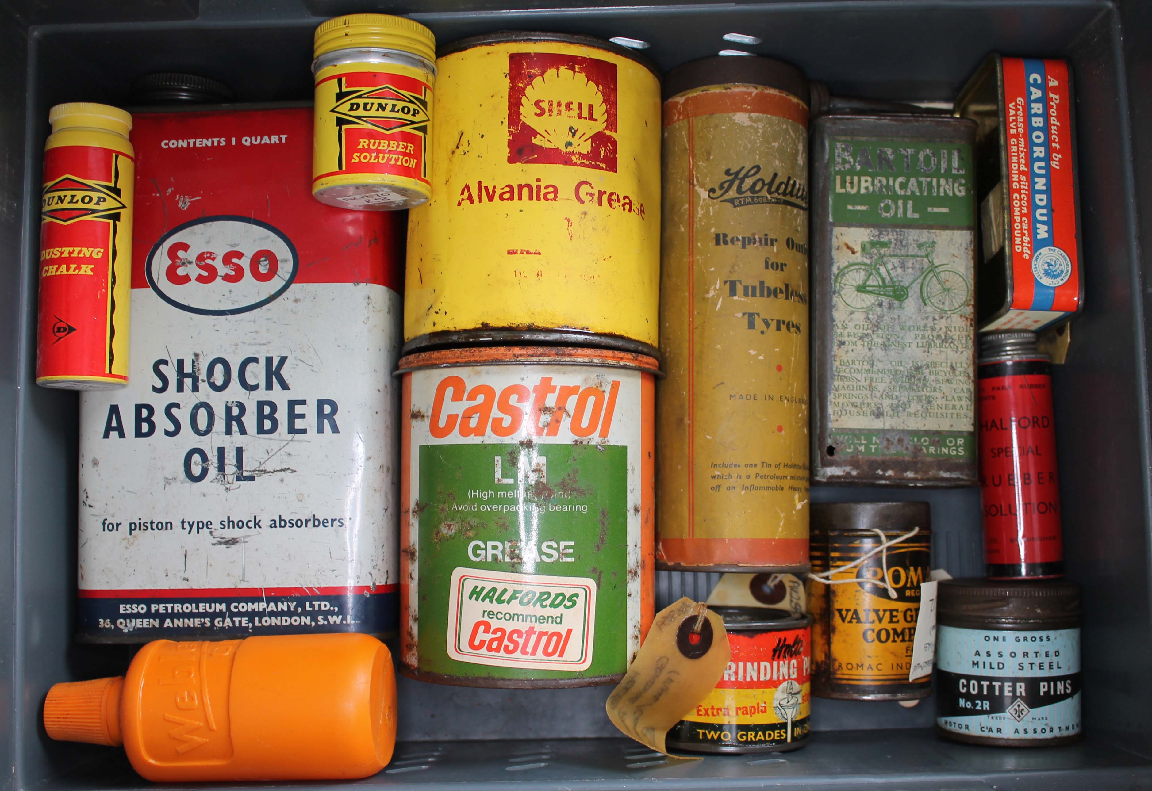 A collection of tins to include Bartoil lubricating oil, Holdtite tubeless tyre repair, Esso shock