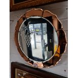 An Art Deco etched glass wall mirror with peach glass panels, diameter 49cm.