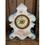 An ornate porcelain mantel clock.