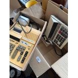 A box containing vintage adding machines.