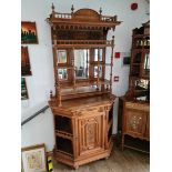 A late 19th century continental walnut mirror back side cabinet with carved panels, turned and