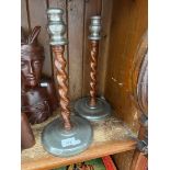 A pair of Homeland pewter twist oak candlesticks.