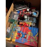 A box of model cars, doll, dominoes, games etc