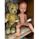A Hump back straw filled teddy bear and a vintage doll