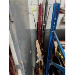 A bundle of approx 12 sea fishing rods, to include 2 with reels.