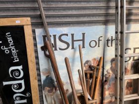 A glass shop sign in wooden frame "Brenda of Bispham" and a mural "Fish of the sea"