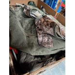 A box of men's hunting gilets.