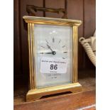 A brass carriage clock, signed 'W Widdop'.