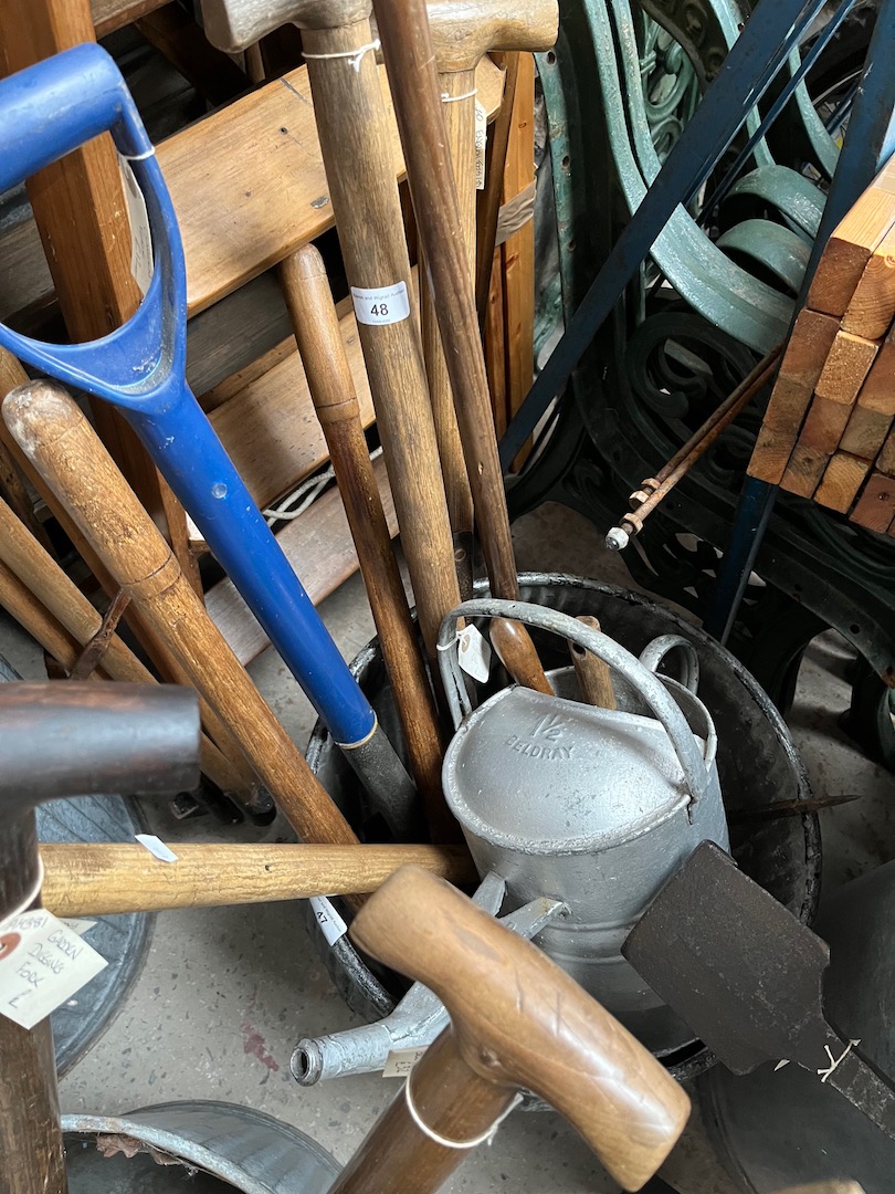 A galvanised watering can, garden hand forks, edging shears, garden spade, garden fork, lawn