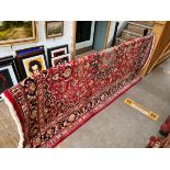 A large Persian Kashan style wool carpet, red ground, 295cm x 202cm (approx).