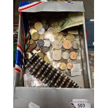 A box of coins, banknotes and bullets