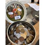 A vintage tin containing world coins.