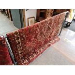 A vintage eastern hand knotted wool carpet, red ground, 196cm x 160cm (approx).