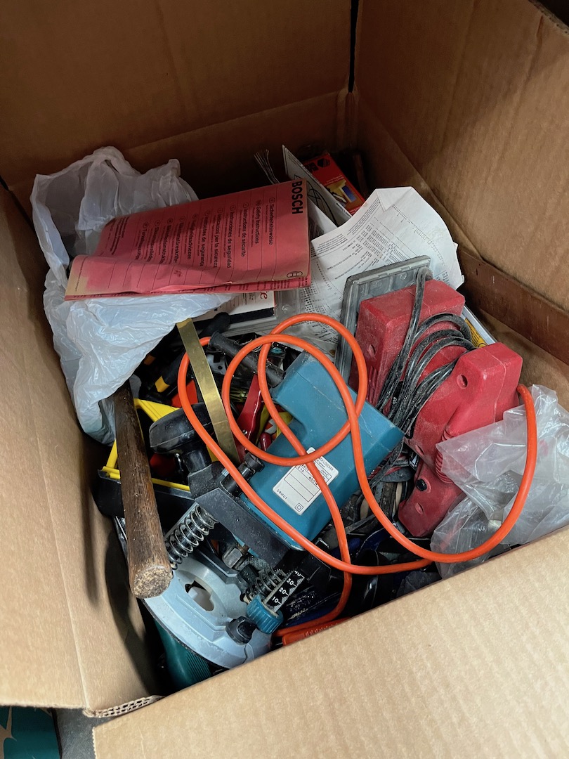 A box of misc tools including router, sander, etc.