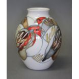 A Moorcroft pottery vase decorated with robins, impressed and painted marks, height 13cm.