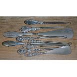 A group of nine hallmarked silver handled button hooks and shoe horns.