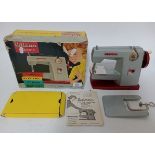 A vintage Vulcan child's sewing machine in original box.