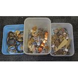 Three boxes of assorted vintage jewellery including brooches, bracelets etc.