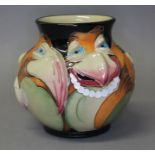 A Moorcroft pottery vase by Emma Bossons, decorated with caricatures of bird faces, impressed and