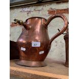 An antique copper jug with brass tap, in the manner of Benson.