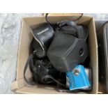 A box of cameras and camera equipment including Olympus OM20 camera, Praktica L camera, lenses,