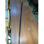 An ebonised and silver topped cane.