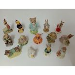 A group of 14 Beatrix Potter, Royal Albert and Royal Doulton figurines.