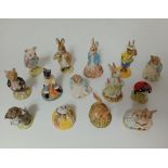 A group of 14 Beatrix Potter, Royal Albert and Royal Doulton figurines.