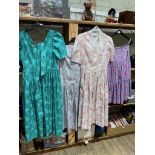 Three vintage 1970s/ 1980s Laura Ashley dresses, lilac pink and green floral print, cream background