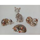 Four Royal Crown Derby cat figurines.