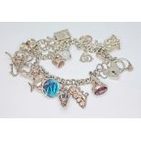 A vintage charm bracelet, marked 'Silver', gross wt. 65.8g.