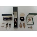 A selection of silver and white metal jewellery items including earrings, bangle, dragon fly brooch,