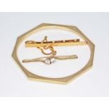 A mixed lot comprising a hallmarked 9ct gold brooch set with colourless stones, a tie clip marked '