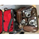 Three vintage Kodak Pronto cameras and a hard camera case.