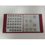 An album containing a collection of various UK coins to include some silver.