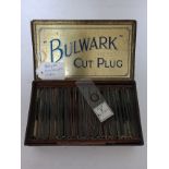 A vintage tobacco tin containing selection of antique microscope slides.