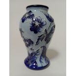 A modern blue Moorcroft vase, decorated with flowers and leaves, impressed and painted marks, height