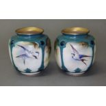 A pair of Hadley's Worcester hand painted porcelain vase, decorated with birds and pine cones,