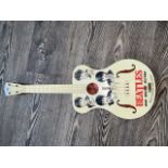 A vintage 1960s Selcol children's guitar featuring The Beatles.