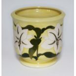 A Moorcroft pottery jardiniere decorated with white lily on yellow ground, impressed and painted