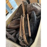 A box of vintage sporting items including football, football boots, leather rugby ball, skull caps