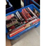 A crate of Man United books and related items.