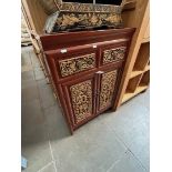 An eatsern carved wood and gilded side cabinet.