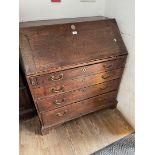 A Georgian oak bureau, standing on bracket feet.