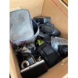 A box of cameras and equipment to include Olympus, Canon, Vivitar, Praktica, etc.