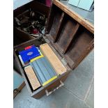 A copper banded wood trunk containing various games, dominoes, chess, canasta etc