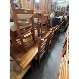 A parquetry inlaid hardwood dining table and six chairs.