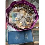 A tub of world coins and banknotes.